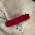 Detailed close-up of red tweed fabric oval hair clip on textured white background - Rectangular Tweed Style / Red