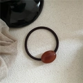 Macro shot of an elegant amber resin oval bead on a high-elastic brown hair tie - Oval Rubber Band / Transparent Coffee