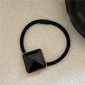 Detail of black elastic hair tie with geometric square resin ornament and gold metal trim - Black