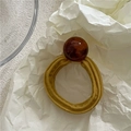 Close-up of mustard yellow elastic hair scrunchie with a large amber resin bead detail - Yellow (Brown Bead)