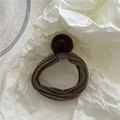Close-up of a dark coffee elastic hair tie with a large polished geometric round bead - Gray (Brown Bead)