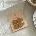 Close-up of amber resin bow hair clips on a light pink display card for styling - Light Coffee