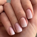 Close-up of nude pink to creamy white ombre press-on nails in a classic square-oval shape - Cdj-1-690
