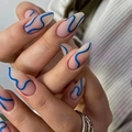 Detailed view of long almond press-on nails with matte nude pink base and blue wavy lines - Cdj-20-7