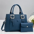 Detail view of teal leather tote set with textured grain and gold buckle accents - Bag and Pouch / Blue