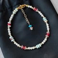 Freshwater pearl and colorful natural stone bracelet with gold hardware on black background - Shell Pearl Shoushan Stone Bracelet