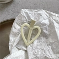 Close-up of heart-shaped cream matte hair clip on an artistic white paper background - Light Cream