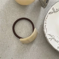Detail of cream acetate curved rectangle accessory with France Handmade text on hair tie - Khaki