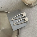 Macro shot of matte silver water-drop hair clips with non-slip duckbill grip mechanism - Flat Hollow Water Drop Style / Matte Silver