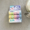 Vue macro de l'ensemble d'élastiques à cheveux colorés pour bébés dans une boîte claire - Violet Clair Orange