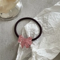 Detailed macro view of a translucent pink resin bow attached to a purple elastic hair tie - Pink Hair Tie