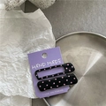 Close-up of black alloy hair clips with pink polka dots on a purple display card - Black Rectangular Polka Dot Style