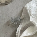 Detail of transparent bow hair clip with ice-crystal texture on a minimalist background - Silver Hair Clip