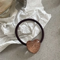 Detail view of coffee brown elastic hair tie with a glittery resin heart pendant - Gold Heart Hair Tie (Brown Yellow Heart Elastic)
