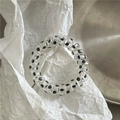 Macro shot of elastic spiral hair tie with black polka dots on transparent material - Transparent Black Dot