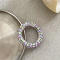 Close-up of elastic spiral hair tie with purple floral graffiti pattern on grey surface - Colorful Light Purple