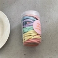 Detail view of colorful high-elastic hair ties in a clear jar with Morandi tones - Creamy Colors