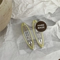 Detail of light green marble texture oval hair clips set in transparent handmade packaging - Beige Oval Style