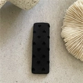 Close-up of a rectangular black fabric hair clip with embossed heart patterns on stone - Rectangular Black Heart