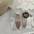 Pair of oval mocha brown metal hair clips in handmade packaging with kraft texture - Small Light Coffee Oval Style