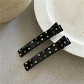 Close-up of black hair clips with colorful polka dots on a natural stone surface - Rectangular Style (Pair)
