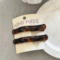 Detail of tortoise shell duckbill hair clips with leopard print pattern on display card - Coffee Leopard