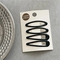 Set of four glossy black leopard style hair clips on card over gray textured surface - Black Combination (Large)