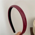 Macro shot of burgundy glossy patent leather padded headband with black anti-slip lining - Burgundy