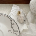 Detailed close-up of cream plush rectangular hair clip with engraved gold metal emblem - Beige Oval (Duckbill Clip)