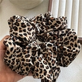 Detail showing the large leopard print scrunchie made of smooth satin-like fabric - Extra Large / Light Leopard