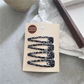 Dettaglio di un set di 4 fermagli per capelli BB con stampa leopardata su cartoncino - Leopardato Tondo Bianco e Nero
