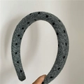 Detail view of the gray woolen fabric padded headband with black polka dot pattern - Light Gray (Thick)