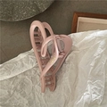 Close-up of matte light pink hair claw clip with gold lettering on elegant background - Hollow Heart Style (C5.4) / Pink