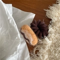 Close-up of wool felt donut hair tie with brown spiral cord on a cozy background - S Baguette Style (J5.4)