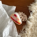 Close-up of handmade wool felt pizza hair tie on a rustic wooden surface - Off-White Pizza Style (J5.4)