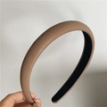 Detailed macro view of tan lychee-textured faux leather headband with non-slip lining - Khaki