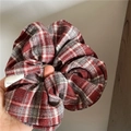 Close-up of red and grey argyle fabric scrunchie with a white handmade label - Wine Red Plaid Scrunchie