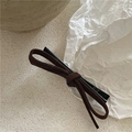 Detailed close-up of the dark brown suede bow hair clip with a metal duckbill attachment - Dark Coffee