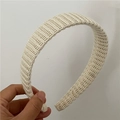 Close-up of ivory knitted headband featuring detailed vertical ribbed texture and soft fabric - Thin Wool / Off White