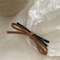 Close-up of brown suede bow hair clip showing textured fabric and black metal duckbill grip - Khaki