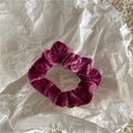 Detailed texture of deep rose velvet scrunchie showing soft fabric and elastic sheen - Rose Red