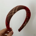 Detailed texture of red and brown thick sponge headband with vintage plaid pattern - Red and Black Check
