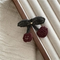 Close-up of handmade crochet cherry hair clip showing detailed red yarn texture and green leaf - J8.1 Cherry Hair Clip