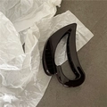 Detailed close-up of a large glossy brown hair claw clip with a hollowed curved design - Dark Coffee