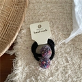 Close-up of handmade purple fuzzy pom-pom hair ties on a cream display card - Purple Pom Pom Hair Ties