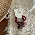 Close-up of handmade colorful yarn ball hair ties on a card for girls and children - Dark Coffee Pom Pom Hair Ties