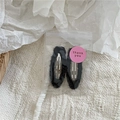 Detail of two black plush faux fur BB hair clips in clear gift packaging with sticker - Black