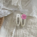 Close-up of cream fuzzy teardrop hair clips in decorative packaging with thank you sticker - Off White