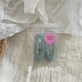 Detailed macro view of cream-toned plush fabric BB hair clips in aesthetic packaging - Mint Green