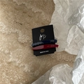Close-up of geometric acetate hair clips in navy blue and burgundy on a JMS card - Red + Navy